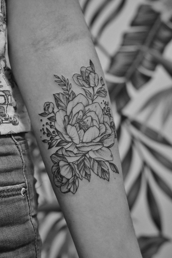 Delicate fine line floral peony forearm tattoo with stippling