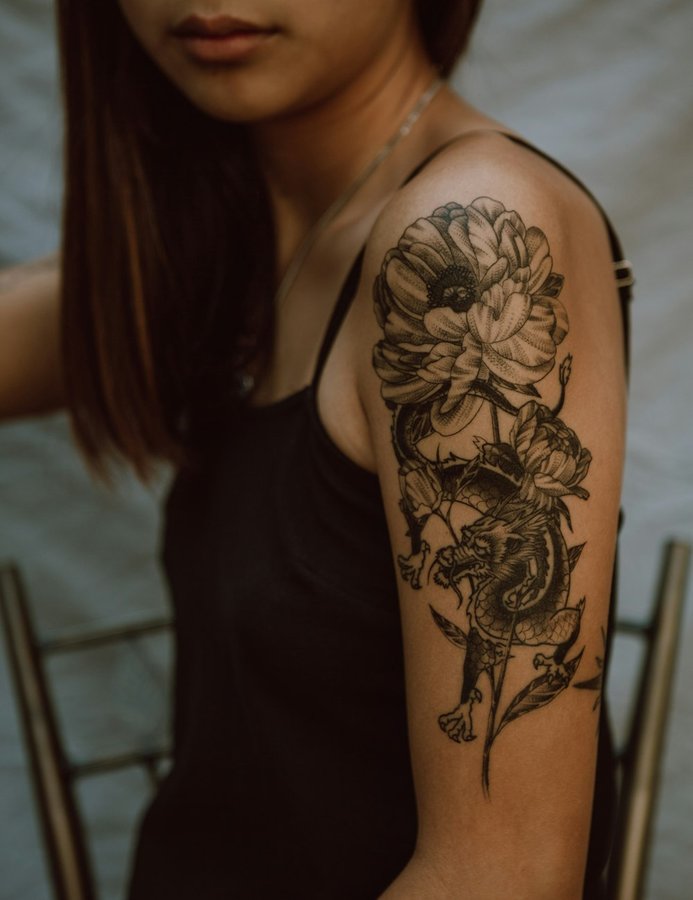 Intricate black and grey Japanese dragon and peony floral tattoo